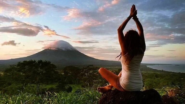 Woman at InanItah Fire Season doing a yoga posture on the slopes of Maderas volcano, with an epic view overlooking the Conception volcano and lake Nicaragua. Community Ometepe, Yoga Nicaragua @ IntanItah Fire Season.
